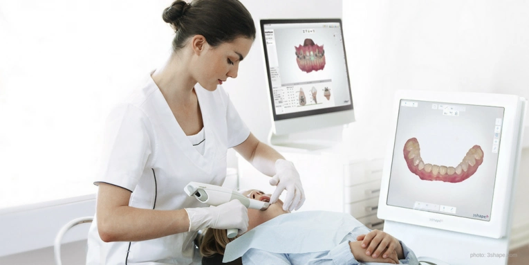 patient getting his teeth scanned using intraoral scanners